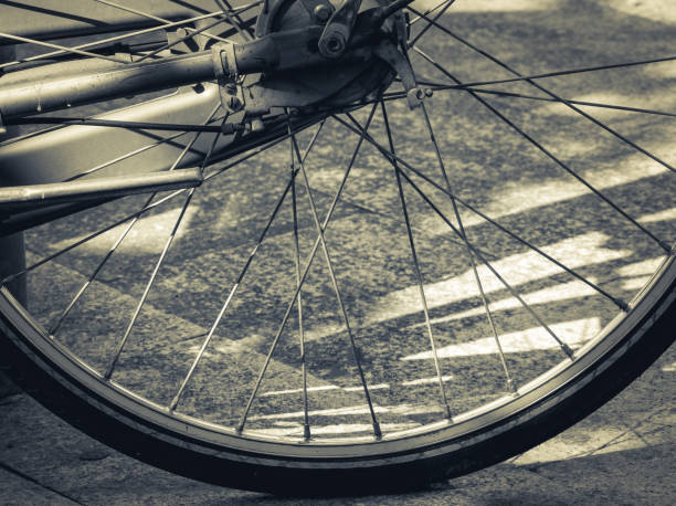 istock Vintage bicycle wheel on the pavement 1253851750