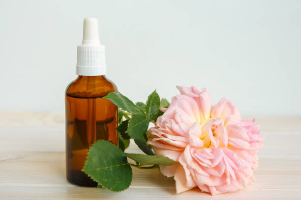 istock Rose and bottle with aromatic oil or medicine 1253854410