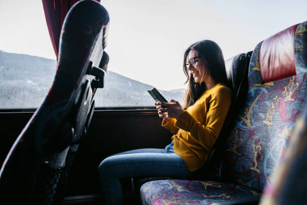 istock Woman reading news on phone while traveling 1253855832