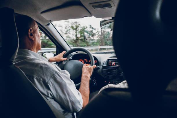 istock Senior man driving car 1253856291