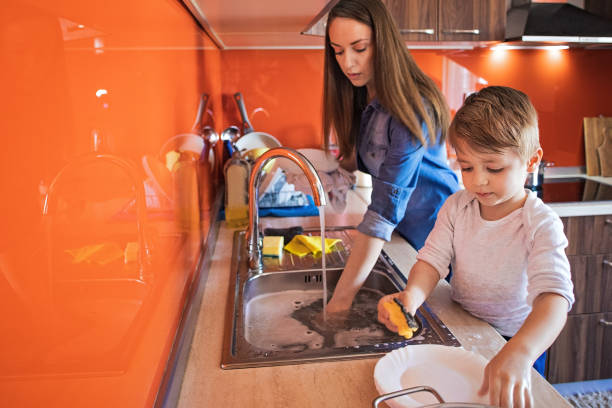 istock Mother and son doing the dishes 1253856335
