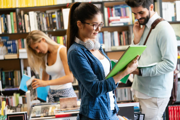 istock Education concept. University students preparing for exam, talking in library 1253856442