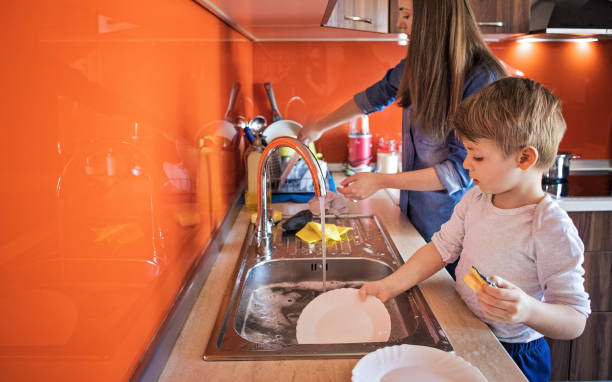 istock Mother and son doing the dishes 1253856446