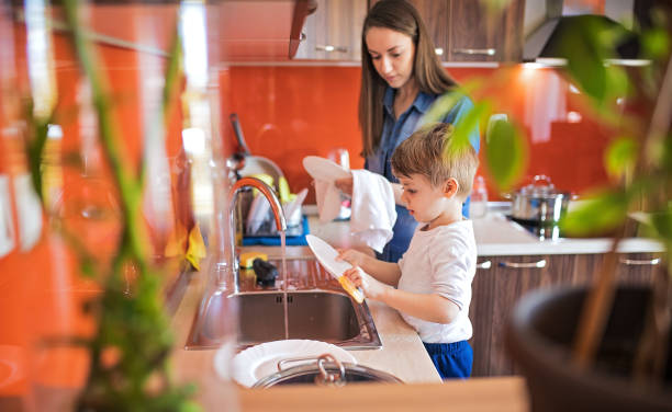 istock Mother and cute son doing the dishes 1253857698