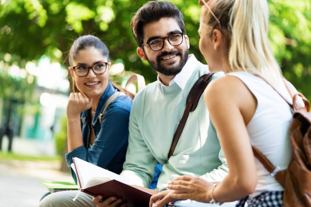 istock Group of happy university students studying together and having fun outdoors 1253857925