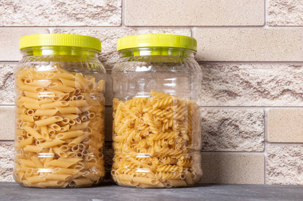 istock Pasta in large plastic jars on the kitchen table. Italian food. 1253857976