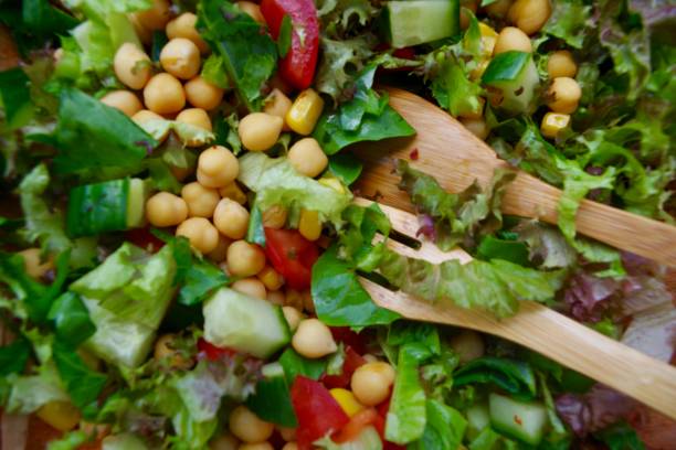 istock Mixed salad with lettuce, tomato, cucumber, chickpeas and sweet corn 1253858622