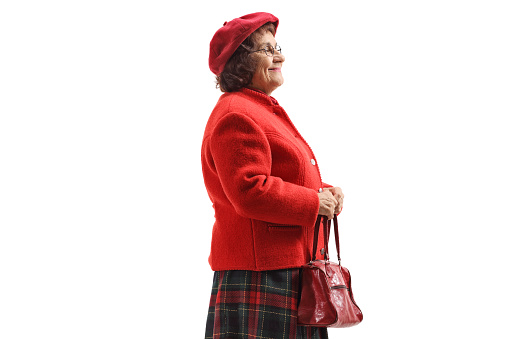 Elderly lady holding a red purse isolated on white background