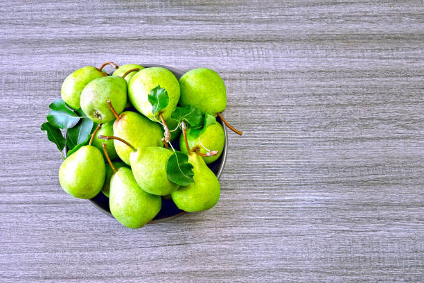 Fresh green pears in a bowl.