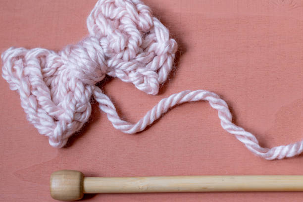 istock Knitting needles and cute hand knit bow 1253862740