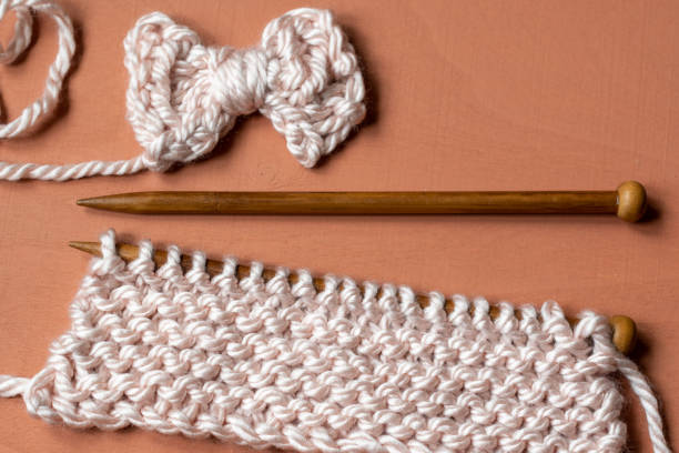 istock Knitting needles and cute hand knit bow 1253863258
