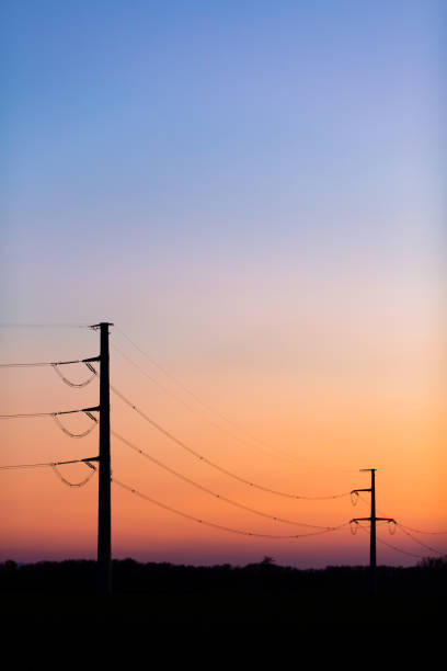 istock High voltage power tower over sunset clear sky, blackout concept 1253868974