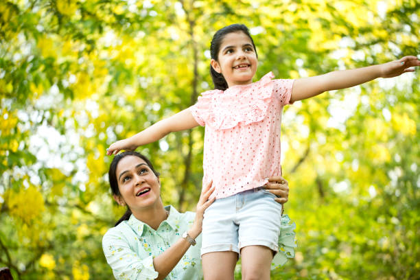 istock Happy mother and daughter at park 1253873311