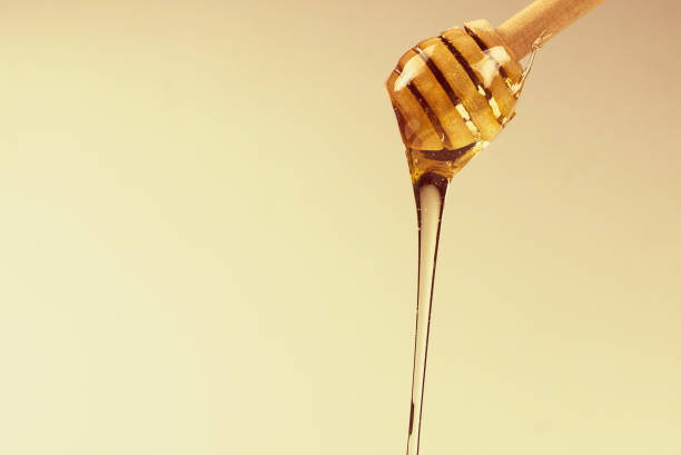 istock Dipper with honey on a white background. 1253874523