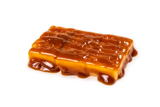 istock Tasty caramel candy isolated on white background. 1253874555