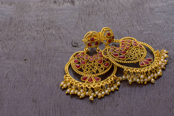 istock Designer gold ear ring with white balls 1253876821
