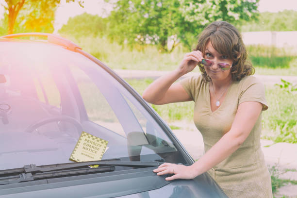 istock woman holding parking ticket 1253877194
