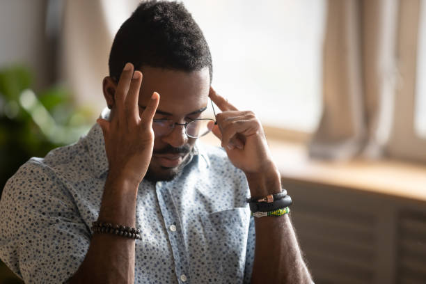 istock African guy closed eyes massaging temples suffers from migraine 1253877202