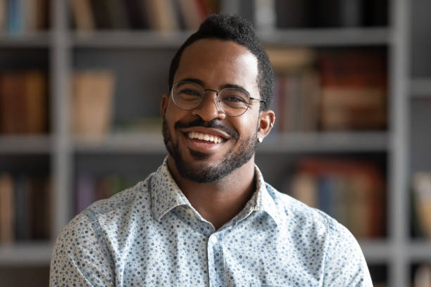 istock Headshot portrait african guy smiling looking at camera 1253877207