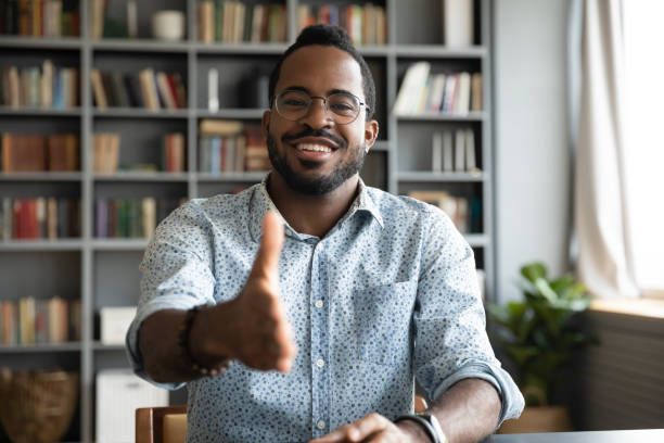 istock African man HR agent greeting applicant stretch hand for handshake 1253877216