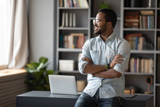 istock African businessman looking out the window dreaming about future 1253877220