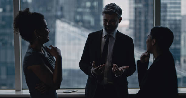 istock Multi ethnic business team talking. City panorama in background 1253878461