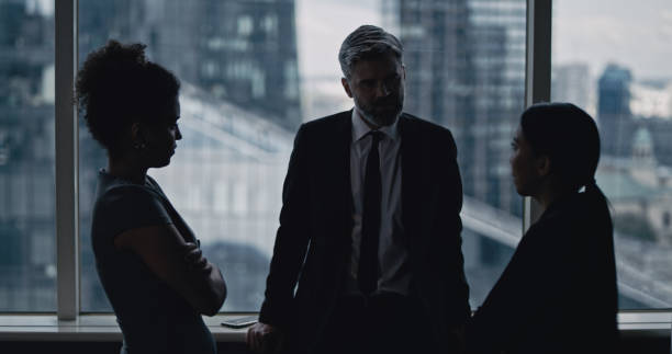 istock Multi ethnic business team talking. City panorama in background 1253878465