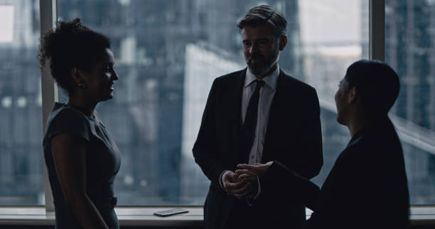 istock Multi ethnic business team talking. City panorama in background 1253878466