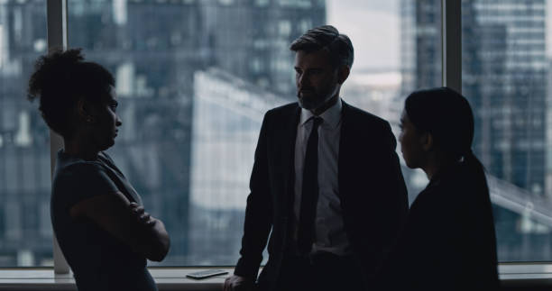 istock Multi ethnic business team talking. City panorama in background 1253878469