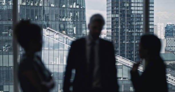 istock Multi ethnic business team talking. City panorama in background 1253878475