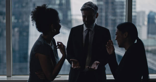 istock Multi ethnic business team talking. City panorama in background 1253878502