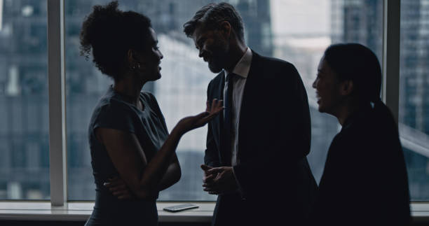istock Multi ethnic business team talking. City panorama in background 1253878630