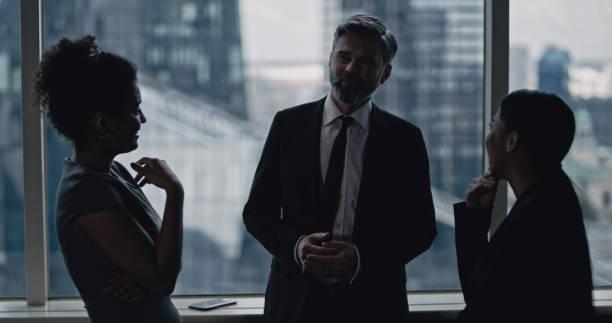 istock Multi ethnic business team talking. City panorama in background 1253878654