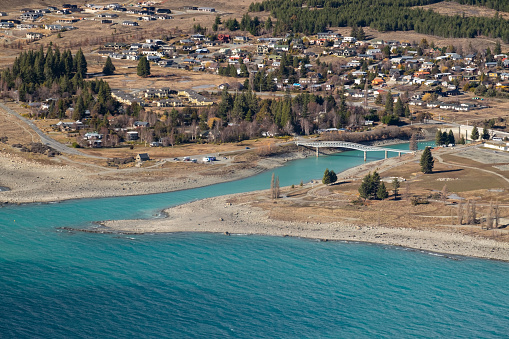 This is the view of the blue waters of Lake Tekapo, as seen from the Mt John Observatory. The water is naturally this astonishing shade of blue due to the \