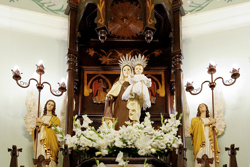 Statue of the image of Our Lady of Carmel, Nossa Senhora do Carmo, mother of God in the Catholic religion, decorated with flowers