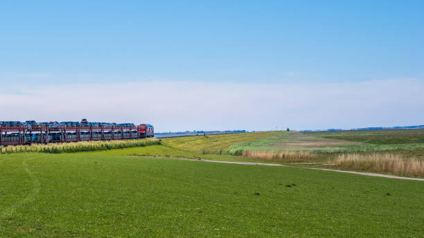 the Sylt shuttle, a Deutsche Bahn car transport train, runs from Niebüll towards Westerland on Sylt, destination germany stock photo