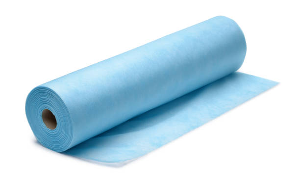 Roll of blue nonwoven fabric Roll of blue nonwoven fabric isolatedon white rolled up stock pictures, royalty-free photos & images