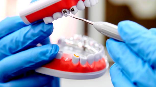 istock a dentist with gloves who is working on a prothesis 1253888684