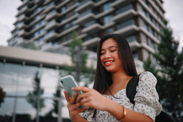 istock Young woman using phone in the promenade 1253891498