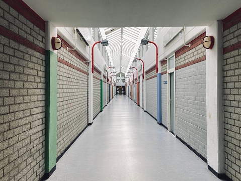 An empty long hotel corridor where thousands residents would walk to and from their rooms.