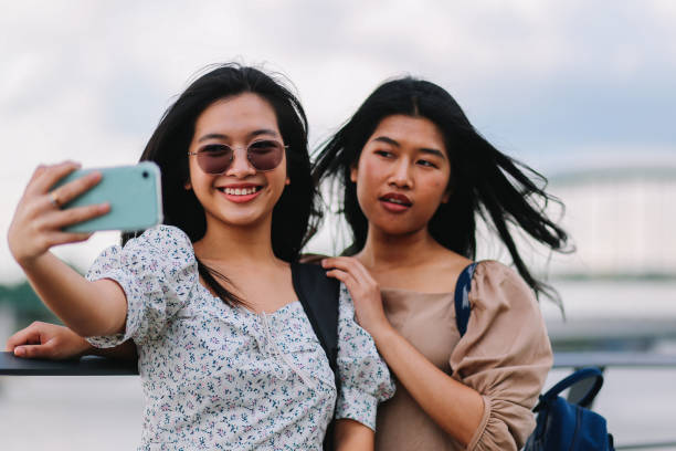 istock Two city girls taking selfies 1253893497