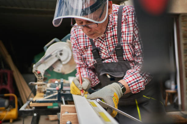 istock Skilled senior carpenter measuring wood before cutting 1253893512