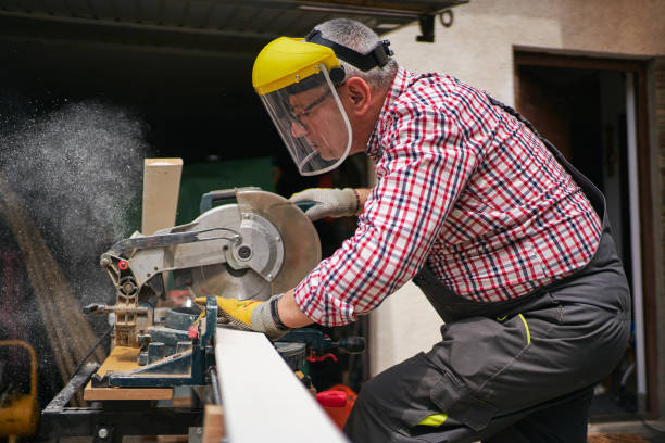 istock Focused and skilled carpenter cutting a plank with a rotary saw 1253893886