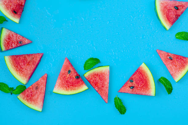 istock Watermelon pattern. Red watermelon on blue background. Summer concept. Flat lay, top view, copy space 1253894047