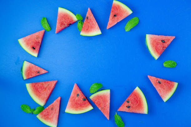 istock Watermelon pattern. Red watermelon on blue background. Summer concept. Flat lay, top view, copy space 1253894149