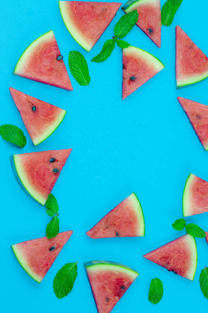 istock Watermelon pattern. Red watermelon on blue background. Summer concept. Flat lay, top view, copy space 1253894150