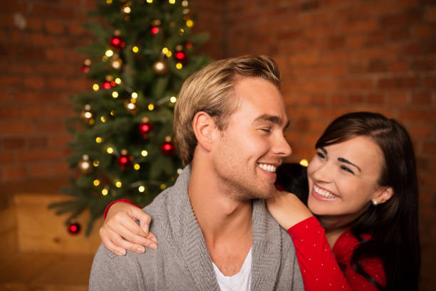 istock Attractive happy couple on Christmas day 1253895221