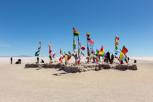Uyuni, Bolivia - october 01, 2018: Flags in front of the Salt hotel near the Dakar Bolivia Monument in Salar de Uyuni, near Colchani, in Bolivia