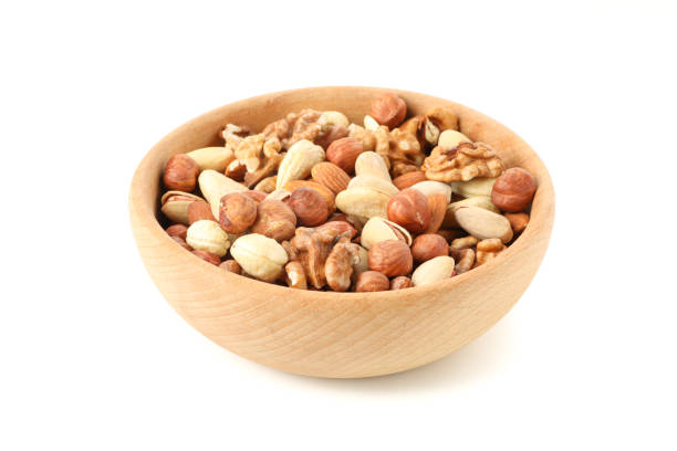 istock Bowl with different nuts isolated on white background. Vitamin food 1253895716