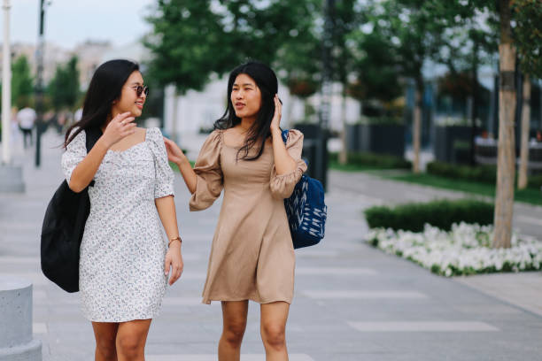 istock Two city girls on a leisure walk 1253897306